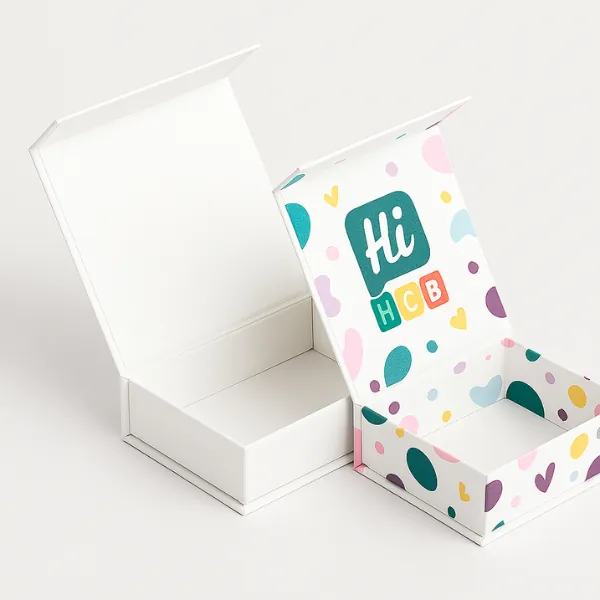 Rigid chocolate gift boxes with hinged lids - one plain white- one printed with pastel patterns- colorful hearts- and Hi HCB logo inside lid- class=